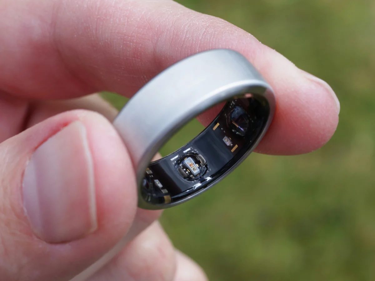 Titanium smart ring held between finger and thumb