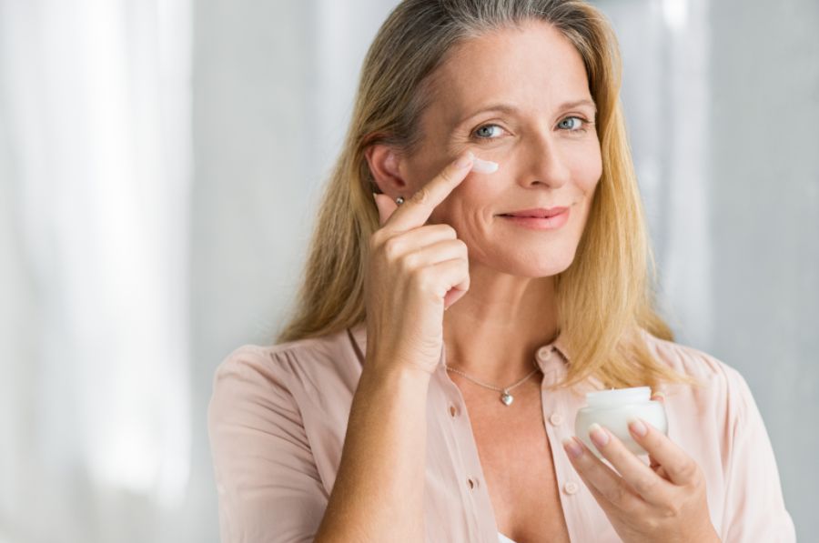 A Woman Moisturizing her Face
