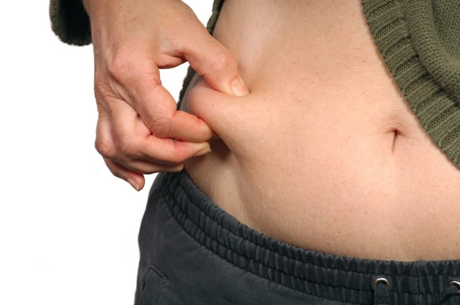 Person Holding Small Piece Food Their Stomach, weight loss treatment in Dubai