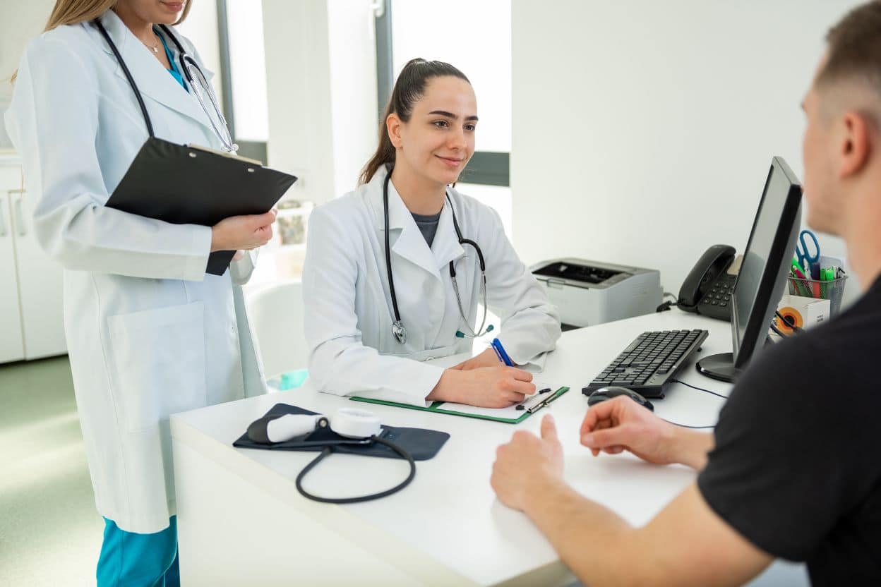Aesthetic Consultation for Fat Reduction Treatments in Clinic Setting Client consultation with medical practitioner discussing fat reduction treatment options in a modern clinic