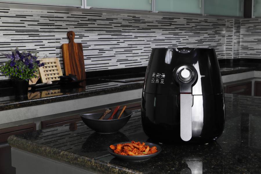 Air Fryer Accompanied by a Plate of Food
