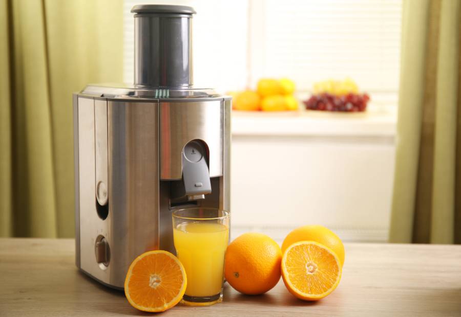 Juicer Making Juice from Fresh Oranges