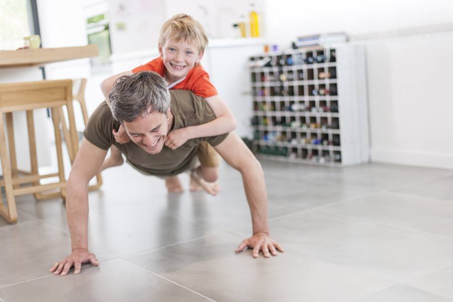 Man Performing Push-ups With a Child on His Back