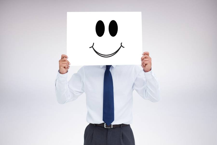Man Holding a 'Happy Face' Placard in Front of His Face