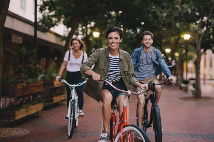 Three People Riding Bicycles