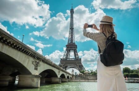 A Tourist in Paris Photographing the Eiffel Tower