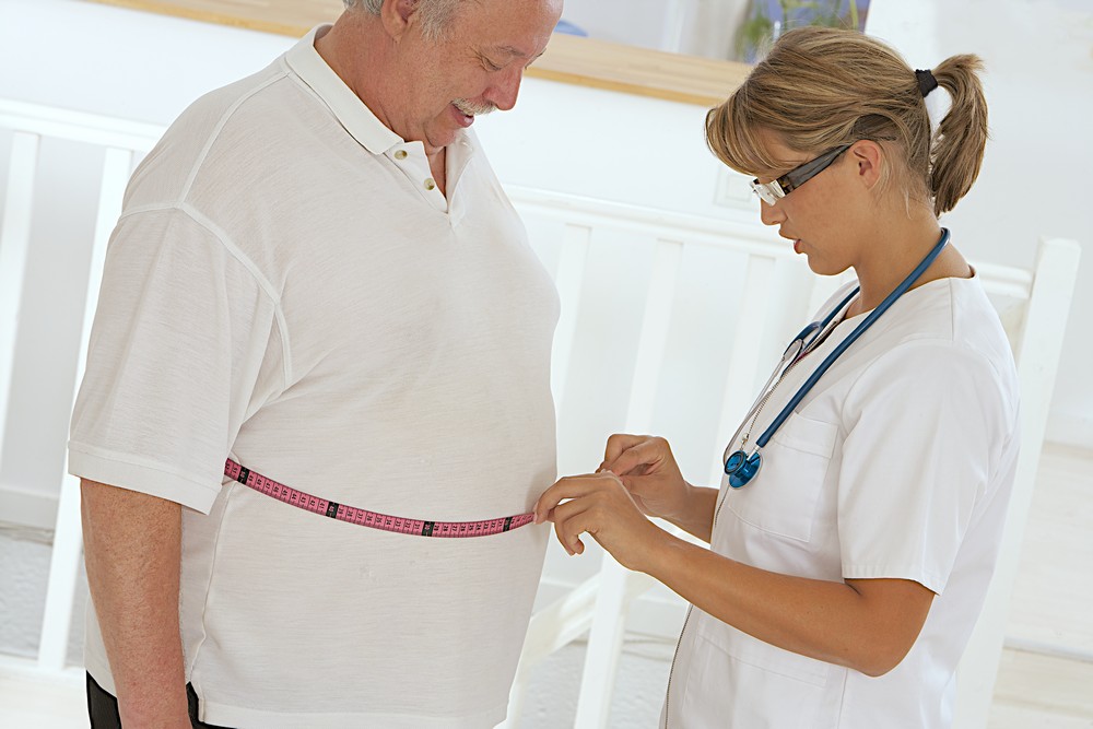 Nurse Measuring Patient's Waist Tape