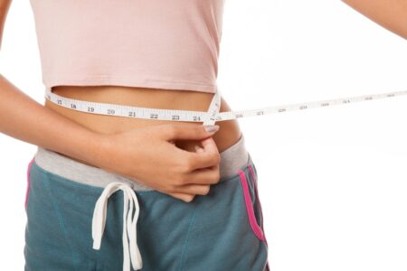 Woman Measuring Her Waist Tape